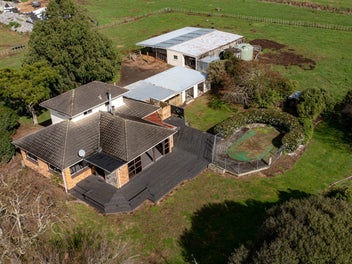 Brick home plus stable block on flat land.