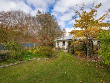 Private half acre paradise with triple garaging!
