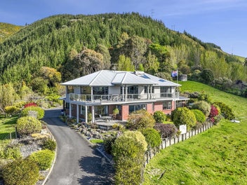 Two homes under one roof with land and views