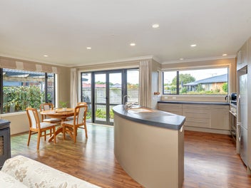 Sun-drenched easy-care living in peaceful enclave!