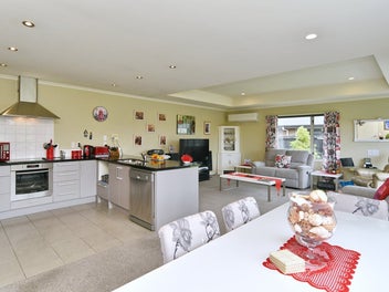 Sun-Soaked And Easy-Care With Double Garage!