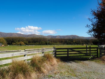 Sheds, A Stream & Mountain Views