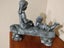 Unusual sculpture of 2 children on a log -joy of storytelling Carousel 3