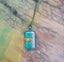 Green & silver metallic foil art glass pendant on new waxed cord. Carousel 1