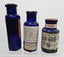 3 x Strychnine labeled blue glass bottles Carousel 2
