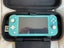 Turquoise Nintendo Switch Lite plus three games and case Carousel 2