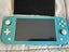 Turquoise Nintendo Switch Lite plus three games and case Carousel 4