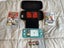 Turquoise Nintendo Switch Lite plus three games and case Carousel 1