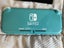 Turquoise Nintendo Switch Lite plus three games and case Carousel 3