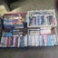 Boxes, boxes and boxes of VHS tapes. Assortment of genres from horrors to comedy Carousel 11