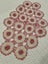 A lovely hand crocheted pink & white doily with raised flowers Carousel 1