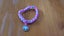 Pink, blue and white loom band bracelet with doughnut charm Carousel 1