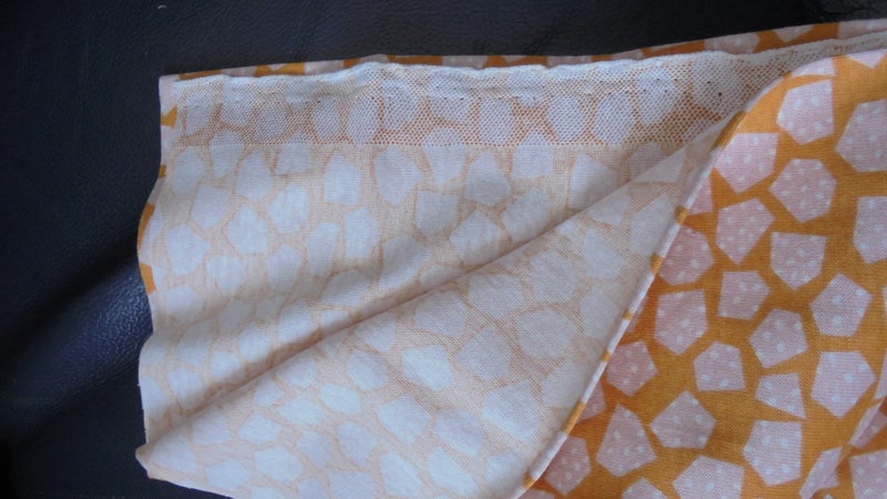 FQ of Orange and Cream Knit fabric as shown Carousel 1