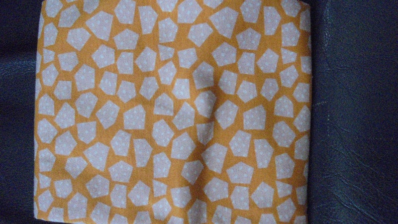 FQ of Orange and Cream Knit fabric as shown Carousel 2