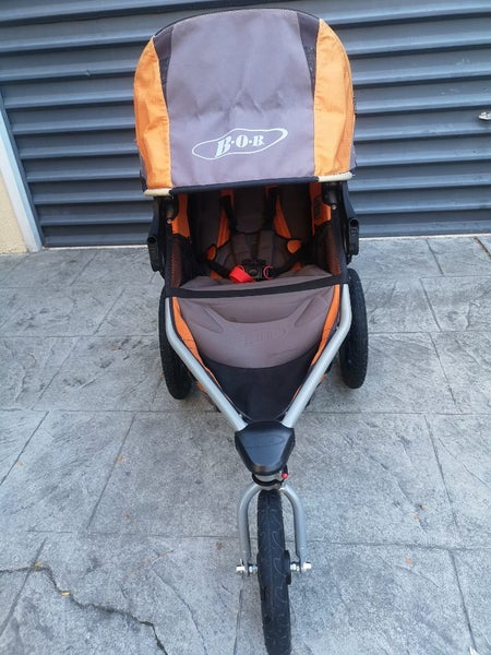 Orange Bob Revolution jogging stroller with accessories Carousel 2