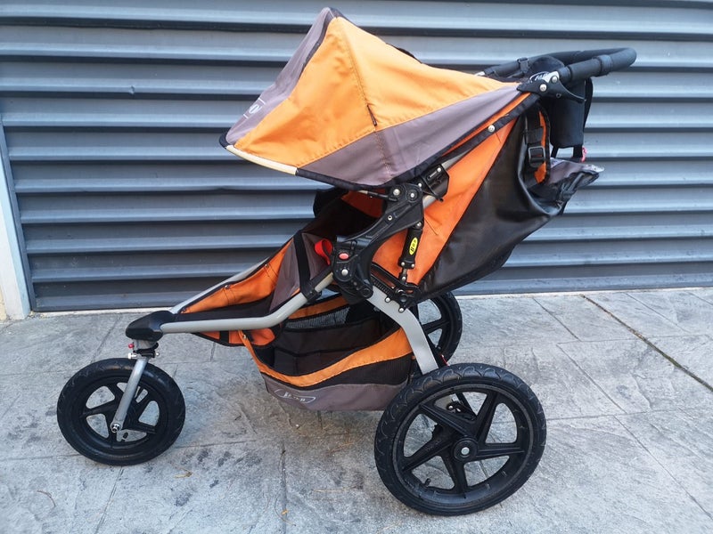 Orange Bob Revolution jogging stroller with accessories Carousel 1