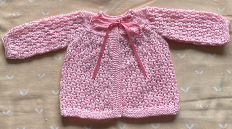 HAND KNITTED BRIGHT PINK 4 PLY LACY JACKET. Carousel 1