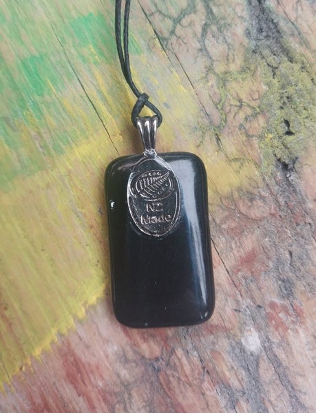 Green & silver metallic foil art glass pendant on new waxed cord. Carousel 3