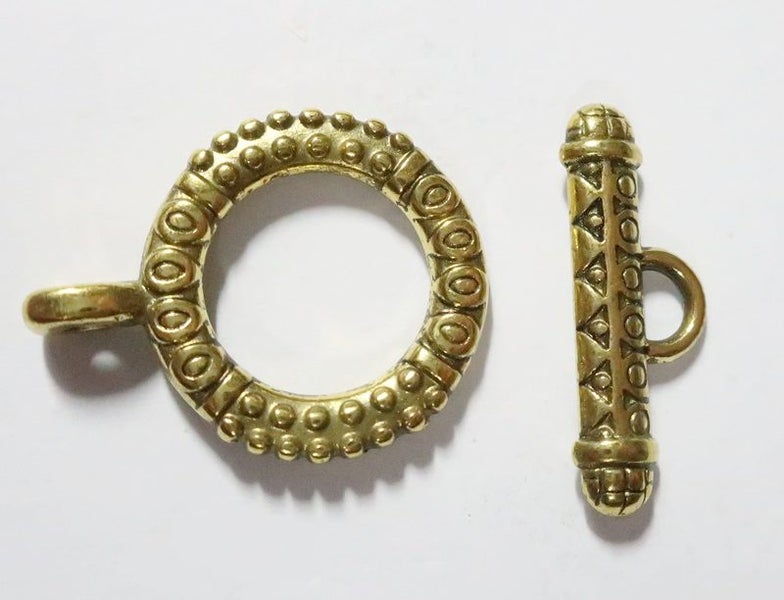 A GOLD TOGGLE CLASP Carousel 1