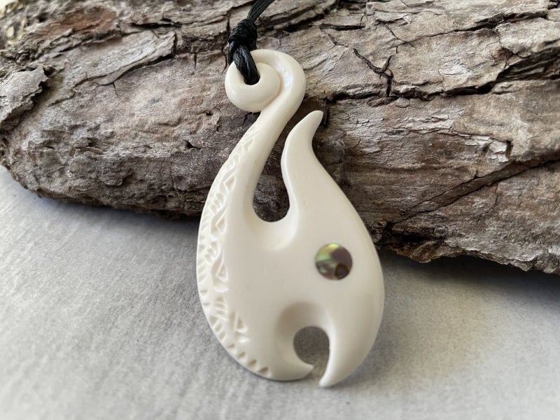 Hand-Carved Bone Fish Hook Pendant with Paua Shell Inlay Carousel 1