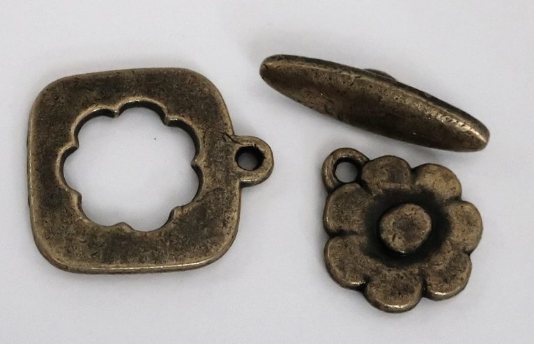 A BRONZE TOGGLE CLASP and FLOWER CHARM Carousel 1