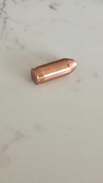 hand poured copper bullet. *not real bullet* Carousel 3