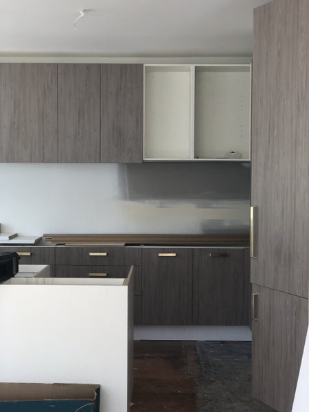 Kitchen cabinets, benchtop and Bosch induction hob Carousel 1