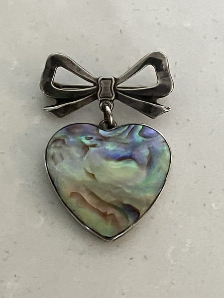 Fabulous vintage sterling silver brooch - paua heart suspended from a silver bow Carousel 1