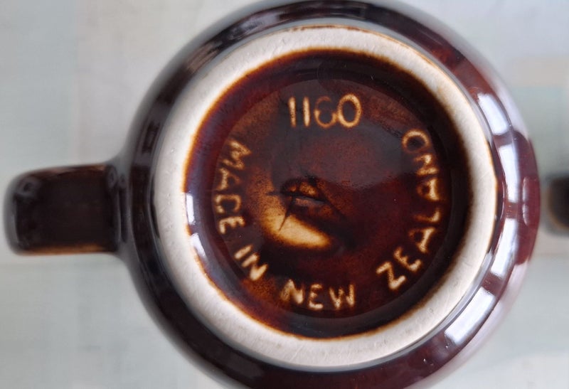 Two Crown Lynn 1160 coffee mugs - one marked 'A' on bottom Carousel 10