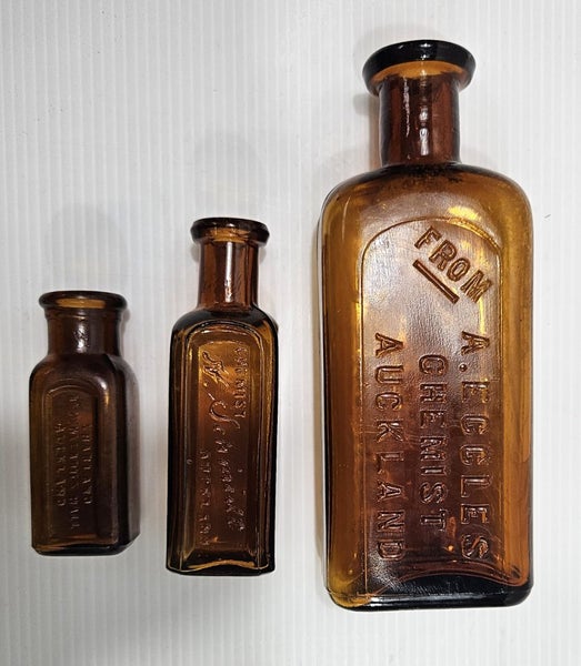 3 x Auckland coloured glass chemist bottles Carousel 1