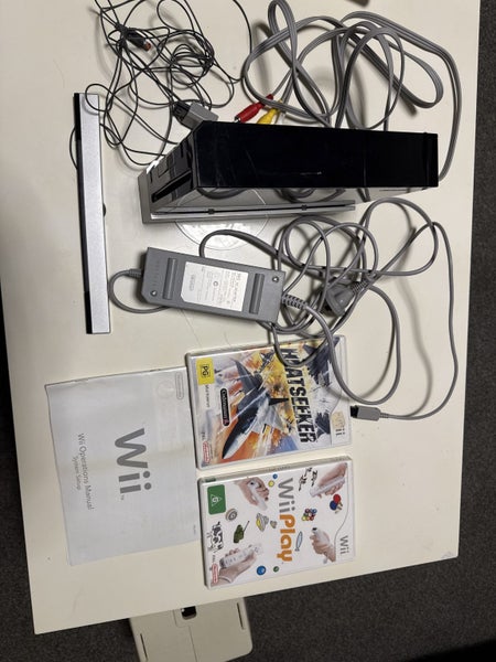 Black Wii console with two games and manual Carousel 1