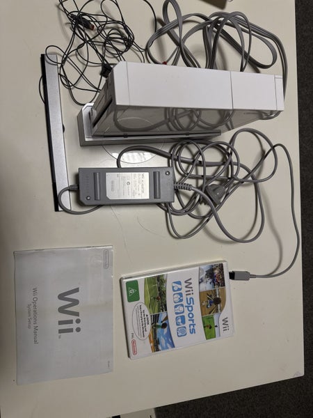 White Wii console with two games and manual Carousel 1