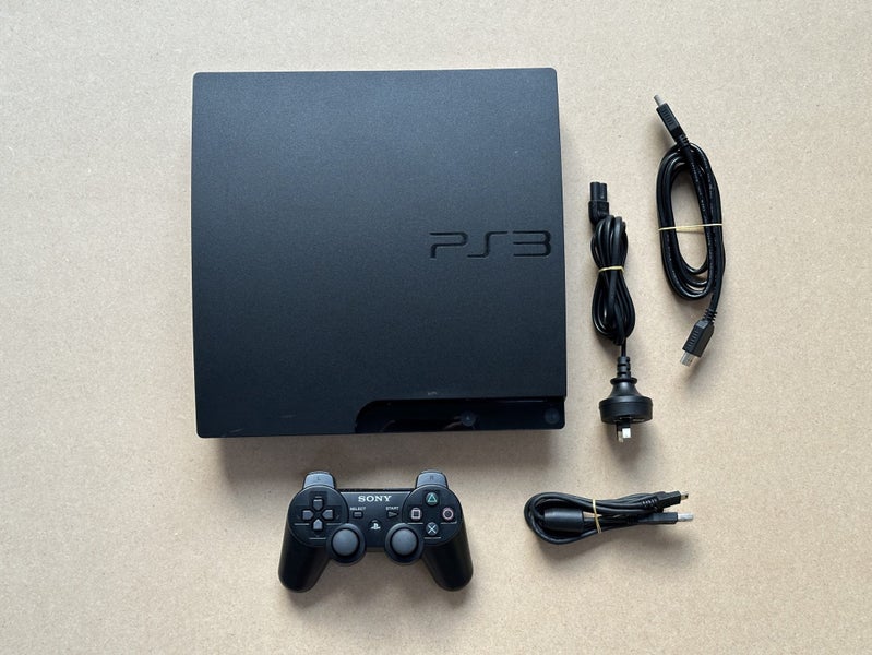 PlayStation 3 with cables and controller Carousel 1
