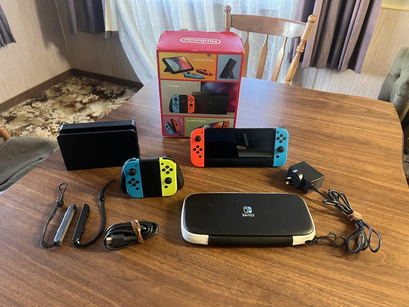Nintendo Switch OLED Bundle + Extra Joy-Cons & Case Carousel 1