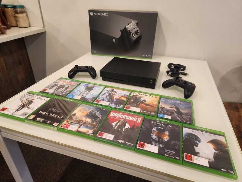 Xbox One X 1TB + 2 Controllers + 11 Games Carousel 1