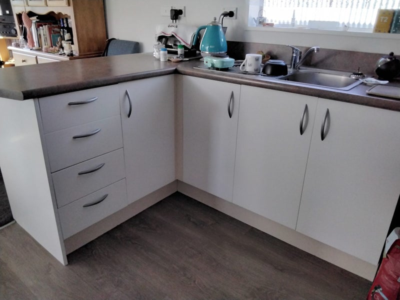 Kitchen sink and benchtop with cupboards. Carousel 2