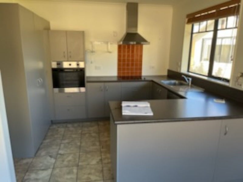 Modern kitchen including appliances rangehood and waste disposal . Carousel 2