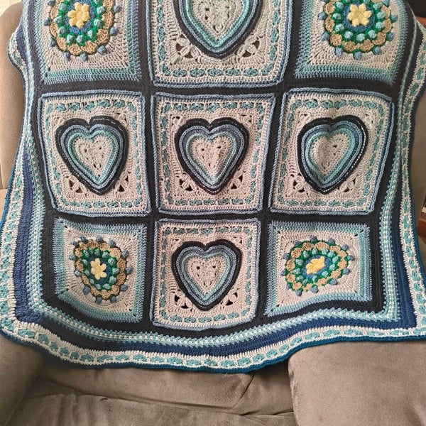 Heart shaped granny square baby blanket in grey and shades of blue Carousel 1