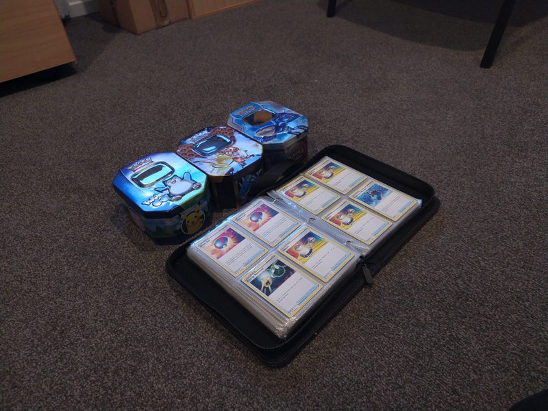 Pokemon collection mixed - approx 300 cards, 3 tin cases and 1 Charizard binder Carousel 2
