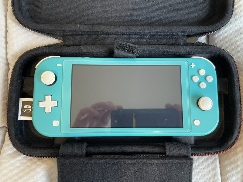 Turquoise Nintendo Switch Lite plus three games and case Carousel 2