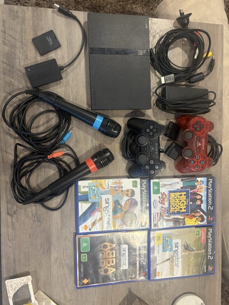 Slim PS2 bundle W sing star mics and 4x games. Carousel 2