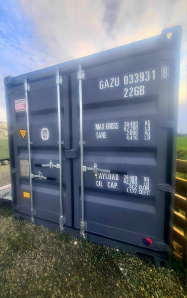 20ft container with heavy-duty shelving and workshop area Carousel 2