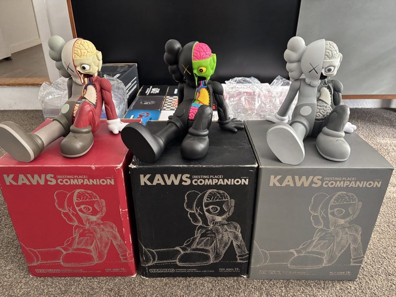 KAWS Resting Place Vinyl Figure (Full Set - Brown, Black & Grey) Carousel 1
