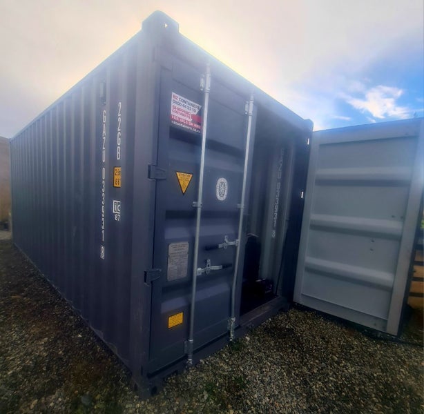 20ft container with heavy-duty shelving and workshop area Carousel 1