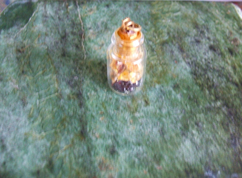 ESTATE MINIATURE FRENCH BOTTLE PENDANT WITH KAURI AMBER/GUM & GARNET INSIDE. Carousel 1