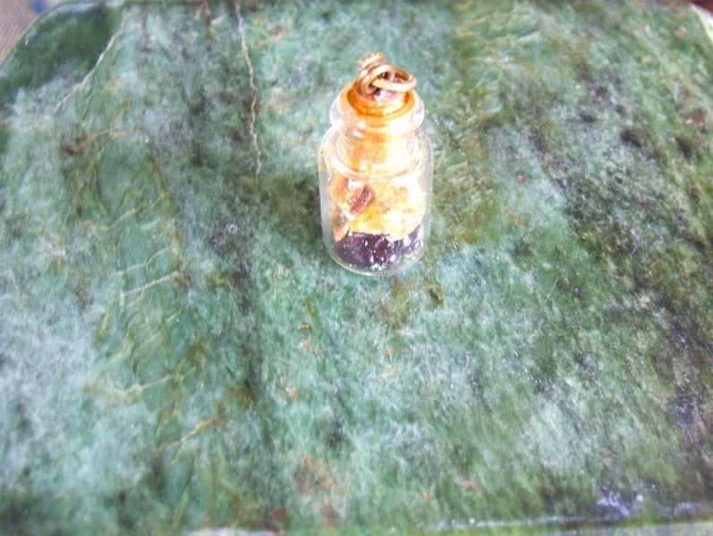 ESTATE MINIATURE FRENCH BOTTLE PENDANT WITH KAURI AMBER/GUM & GARNET INSIDE. Carousel 2