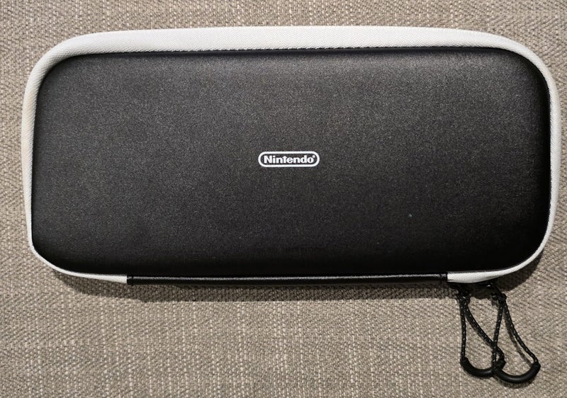White Nintendo Switch OLED with screen protector, case, and handheld controller Carousel 5