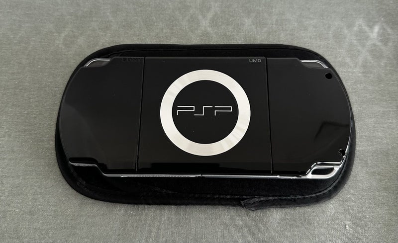 PlayStation Portable (PSP) 2000 – Piano Black | 64GB | Fully Set Up63617292648707112