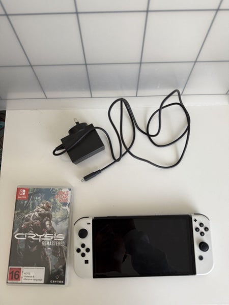 Nintendo Switch OLED – Excellent Condition + Crysis Game + Original Charger Carousel 1