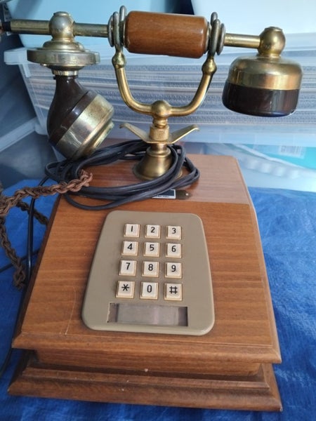 An old rotary design landline phone with buttons. Carousel 1